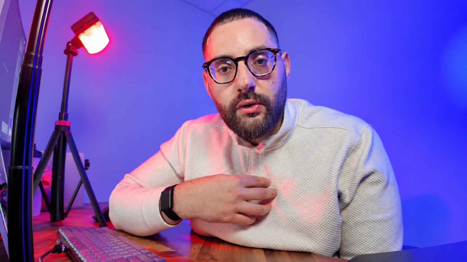 Subhi Saadeh at his Let’s Combinate recording desk with blue and red studio lighting